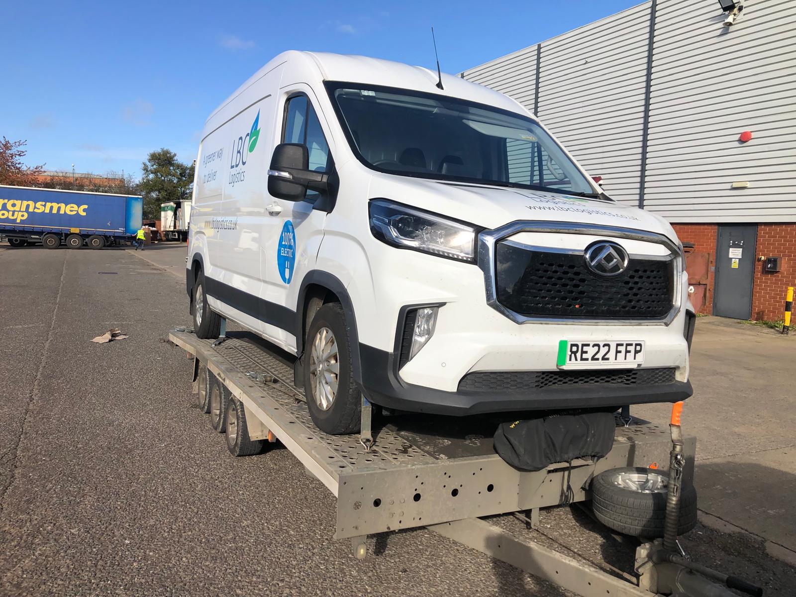 White LDC Logistics electric van on flatbed trailer