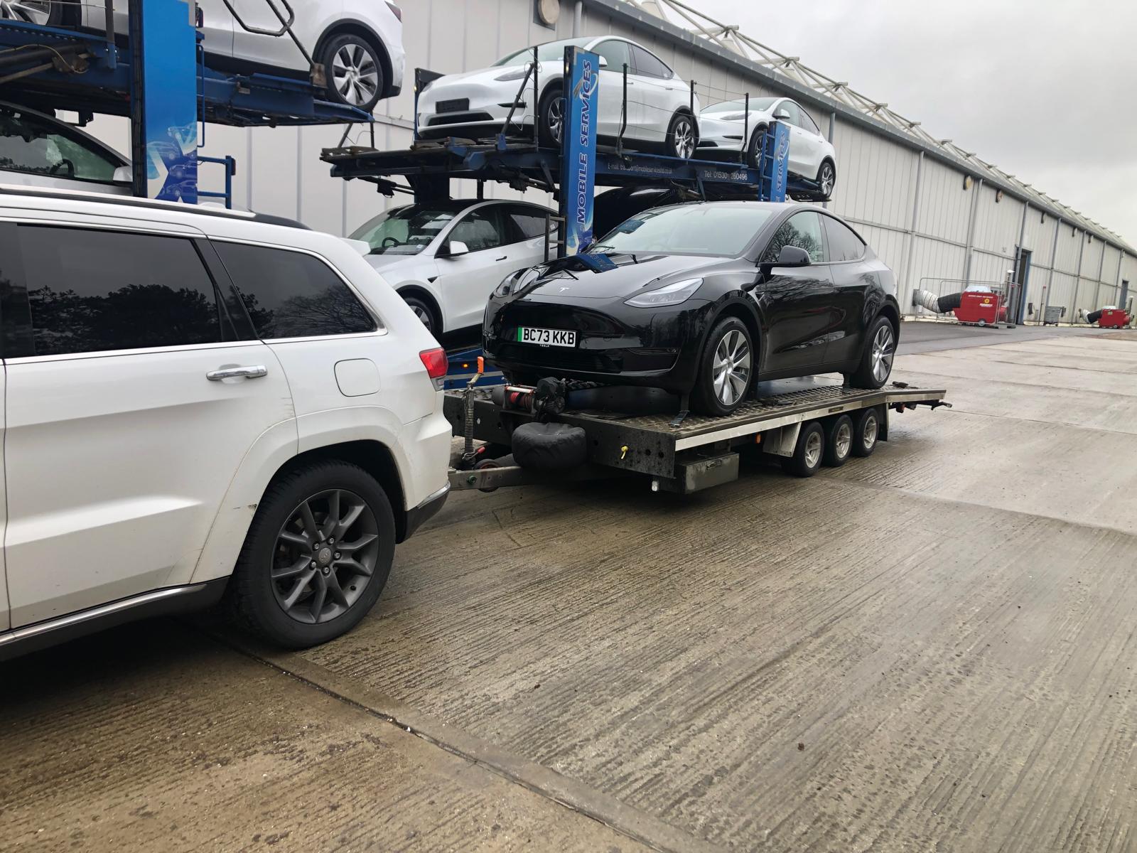 Tesla Model 3 on flatbed trailer at service center