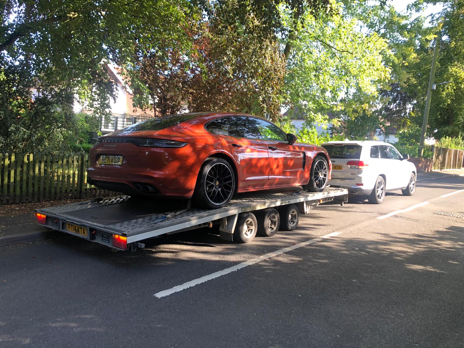 Orange Porsche Panamera on flatbed trailer